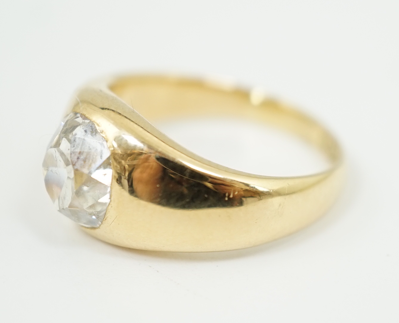 A George V 18ct gold and solitaire diamond gypsy set ring